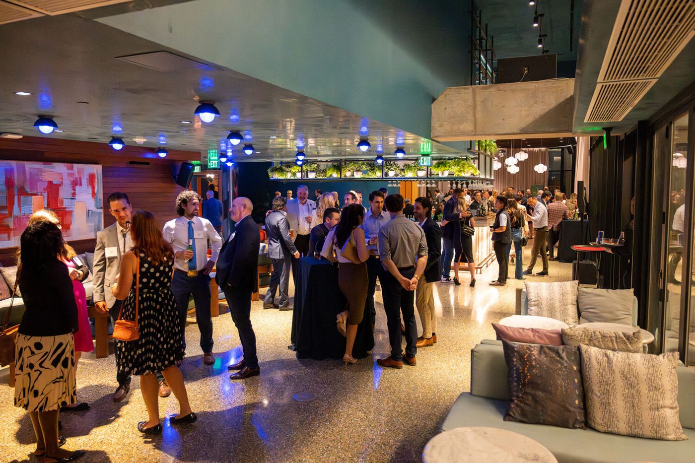Attendees networking on the floor of a Dallas corporate event