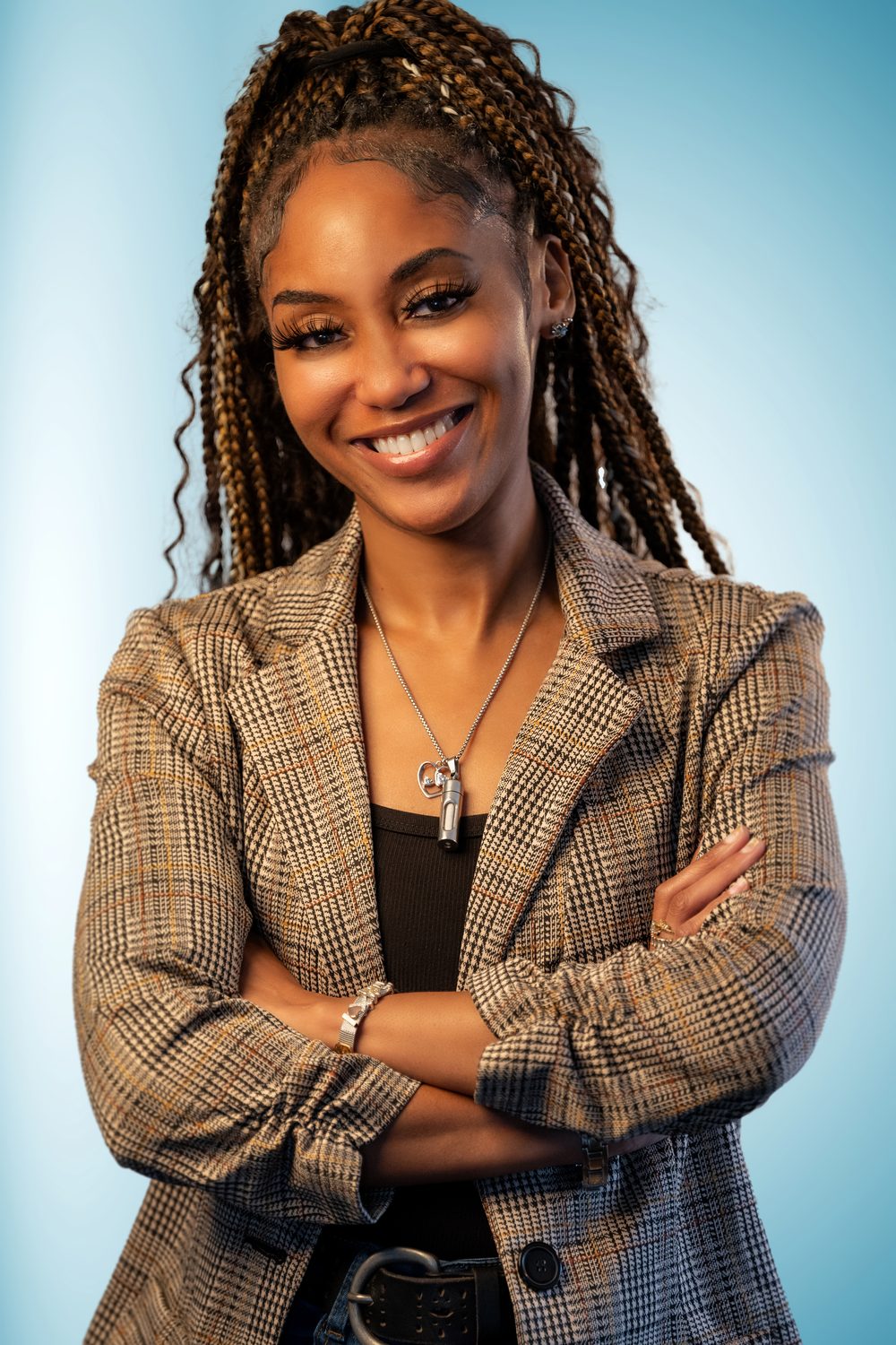 Businesswoman with braids in a plaid blazer on a bright blue background