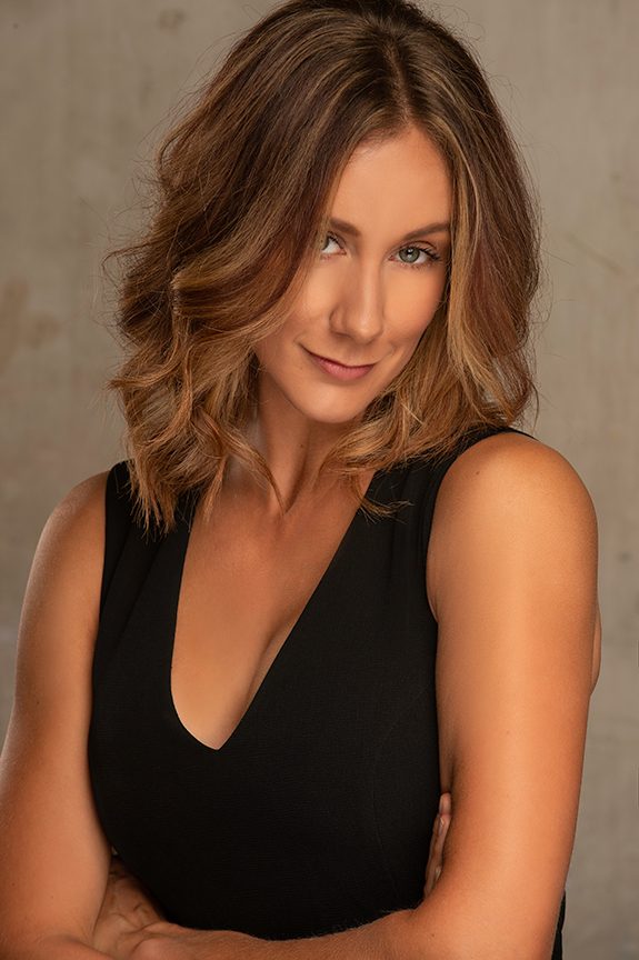 Business owner in a black top against a concrete background