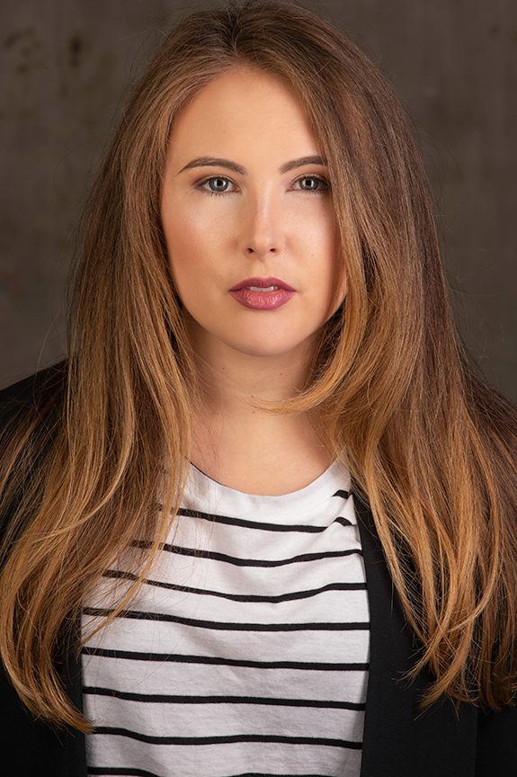 Professional in a white coat and pink top on a warm background